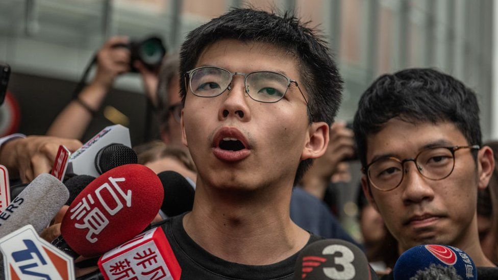 Hong Kong: Joshua Wong jailed over banned Tiananmen vigil