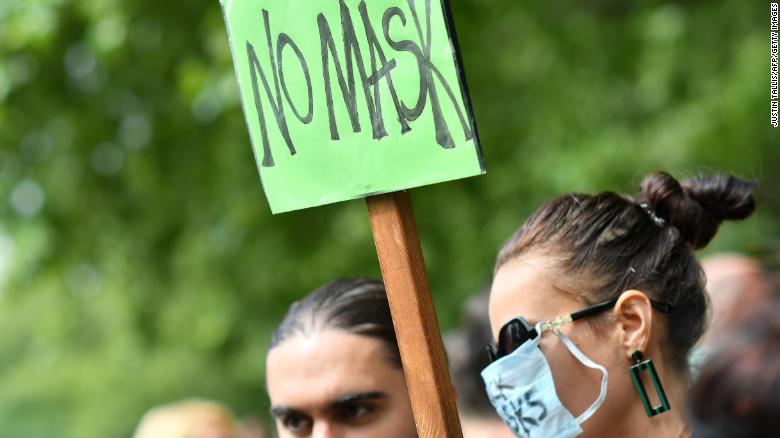 Hundreds of demonstrators, some wearing masks, protest against mask-wearing in London